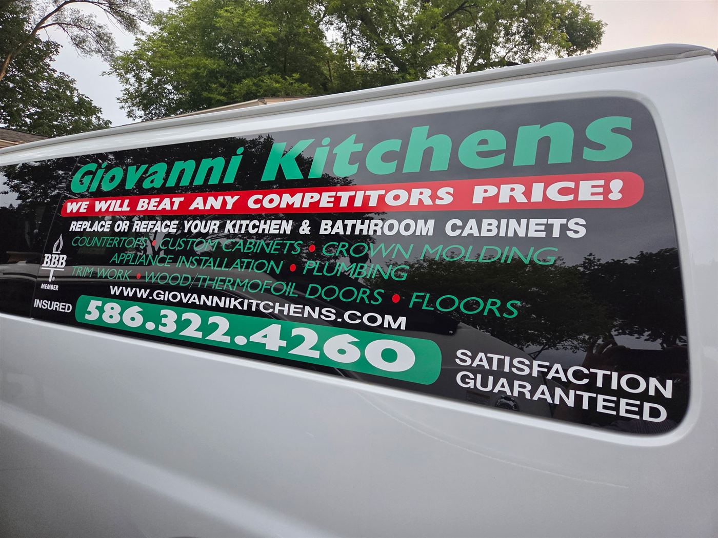 The Giovanni Kitchens van: green, white, and red lettering reading We Will Beat Any Competitors Price, BBB Member, Insured, 586-322-4260